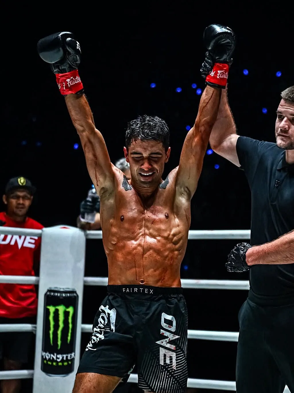 Rui Botelho with both arms raised after a ONE Championship win