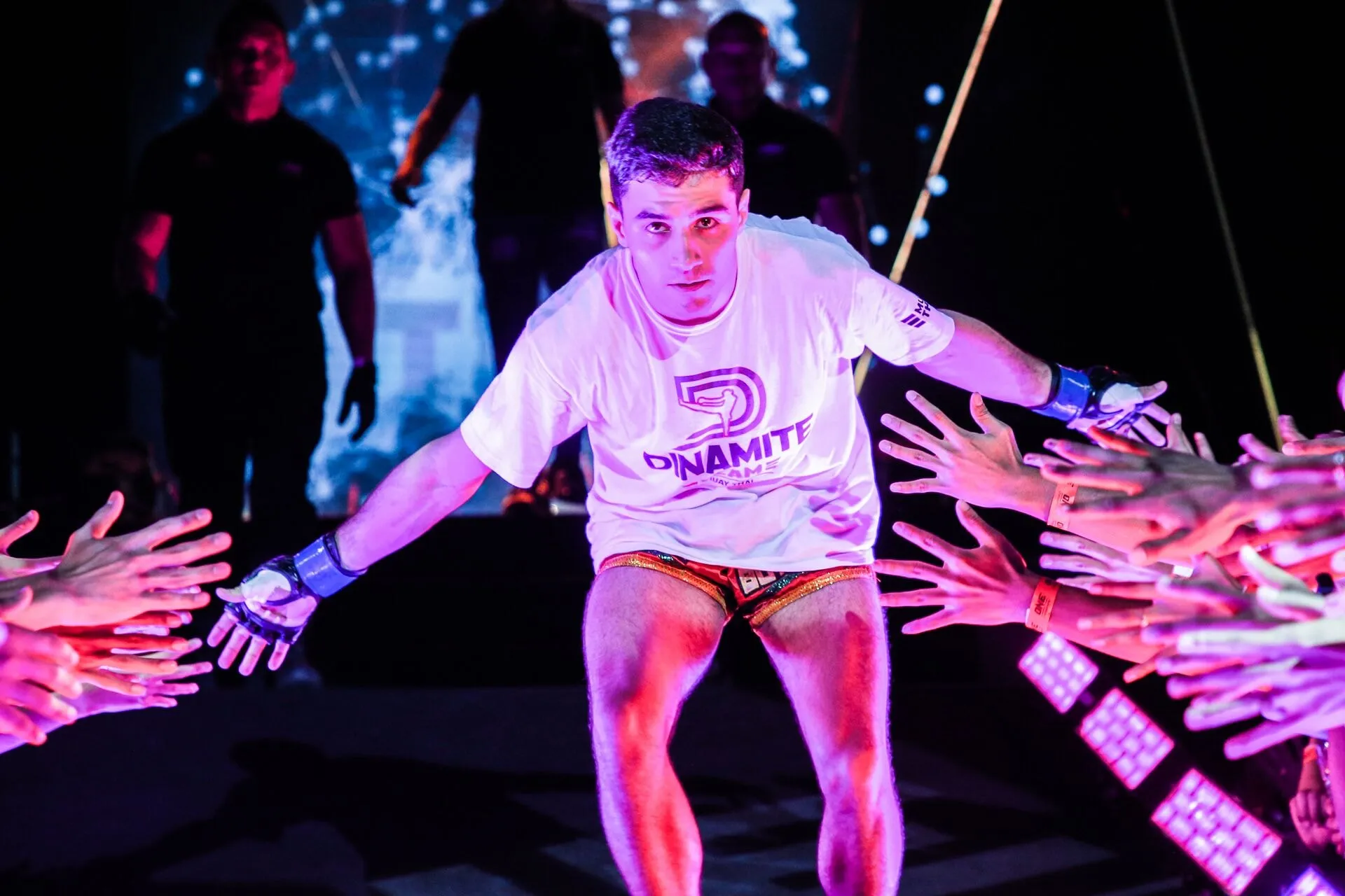 Rui Botelho walking out to the ring through a corridor of outstretched hands