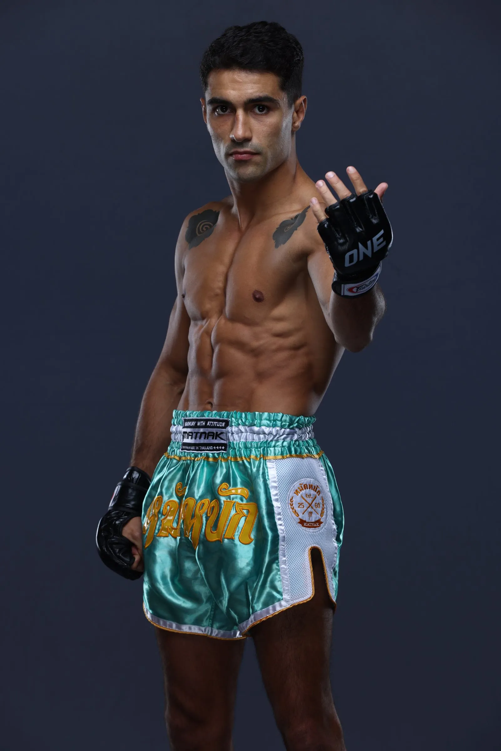 Rui Botelho in Muay Thai shorts and ONE gloves, photographed in studio
