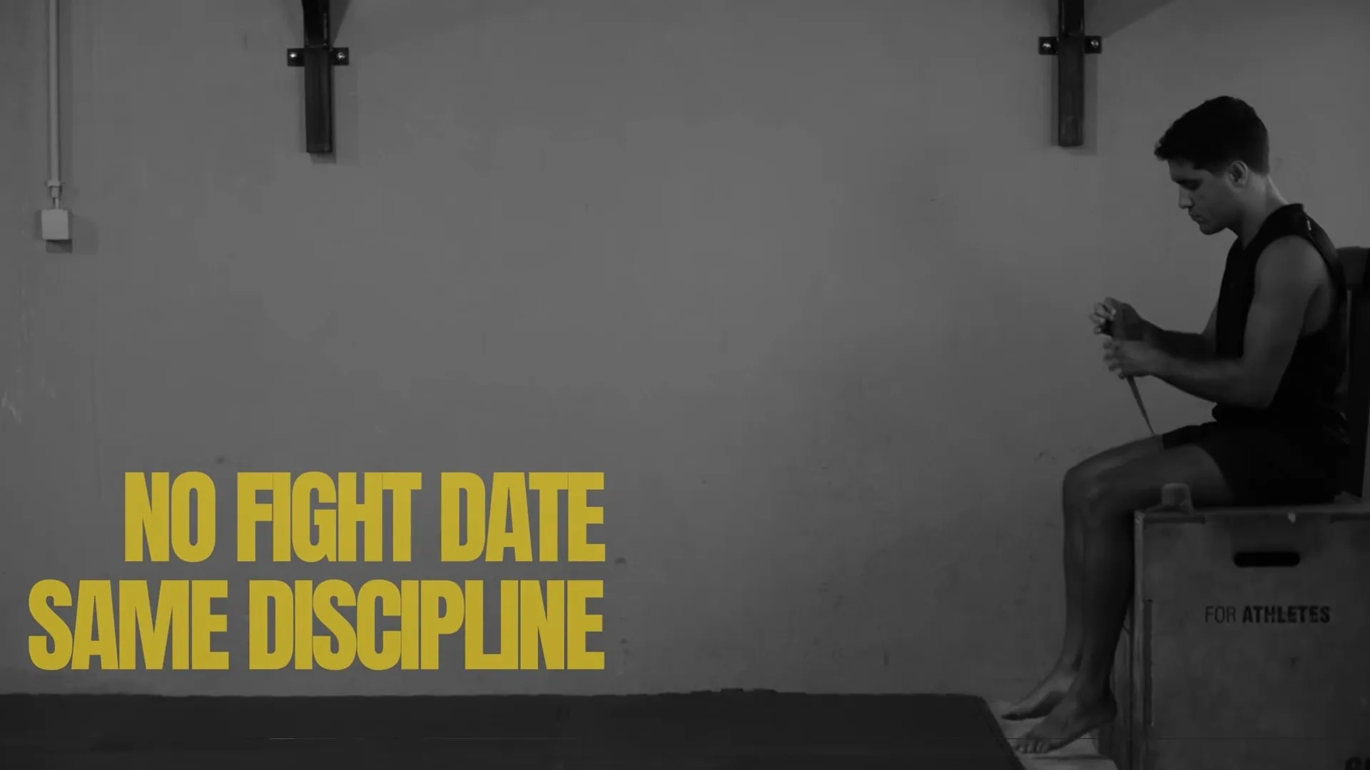 Rui Botelho seated in the gym wrapping his hands, captioned no fight date same discipline