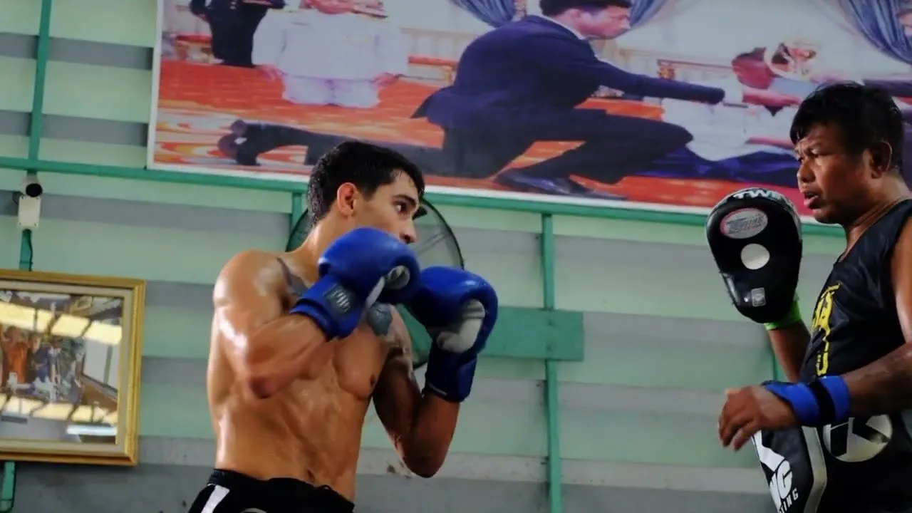 Rui Botelho working pads with a Thai trainer at Pk Saenchai gym